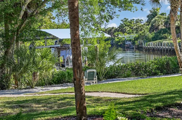 a bedroom with a bed a painting on the wall and a large window