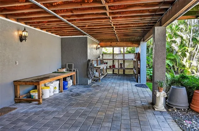 a view of an chairs and swimming pool in the back yard