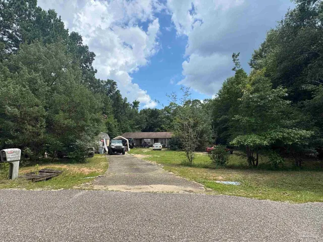 a view of a yard with swimming pool