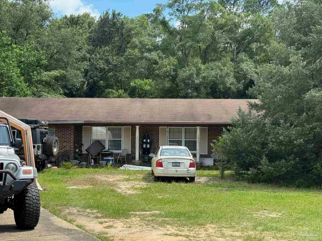 a view of a car parked in front of house