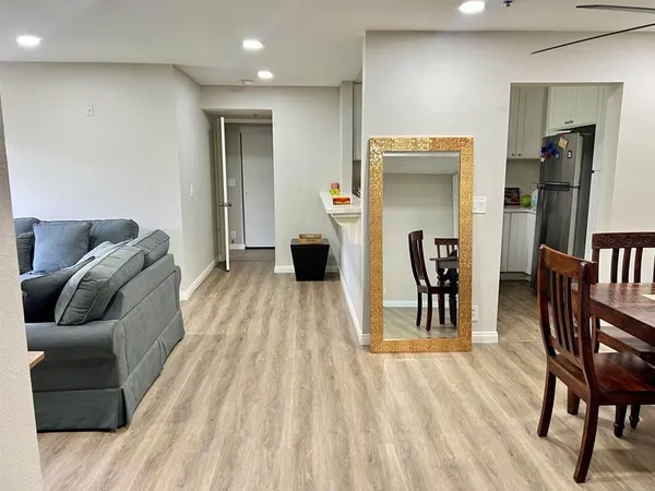 a living room with furniture and a wooden floor