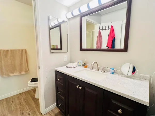 a bathroom with a sink vanity and mirror