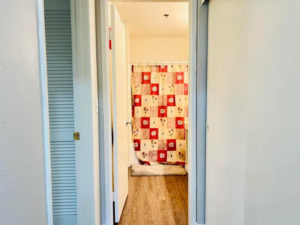 a view of a hallway with a door and a window