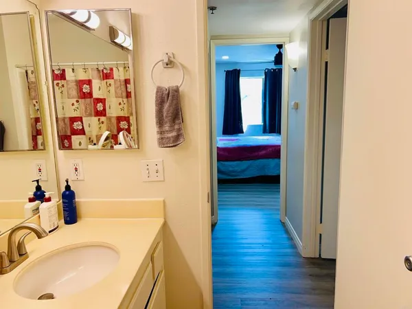 a bathroom with a tub sink and mirror