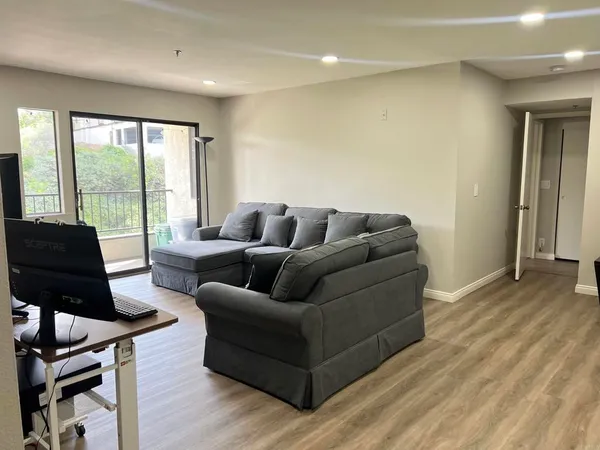 a living room with furniture and a floor to ceiling window