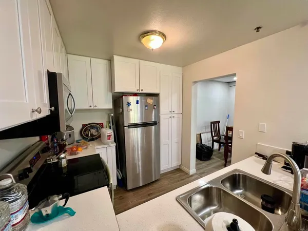 a kitchen with a refrigerator and a sink