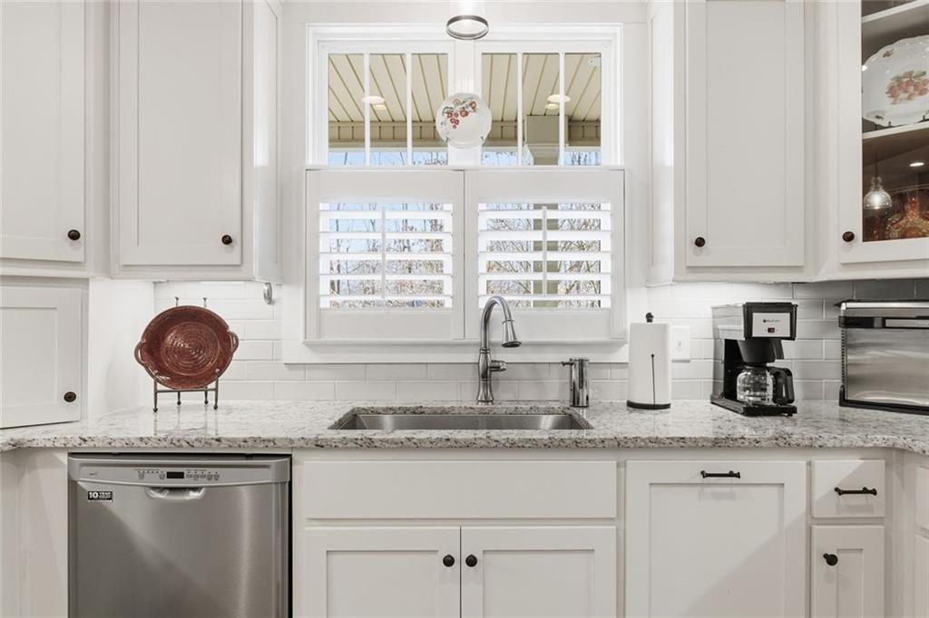 7671 Fern Lane Lula, GA 30554 - Photo 17 of 67 a kitchen with granite countertop white cabinets and window