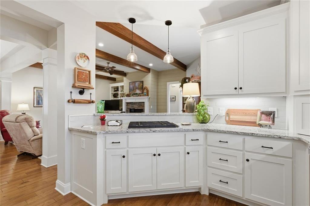 7671 Fern Lane Lula, GA 30554 - Photo 19 of 67 a kitchen with stainless steel appliances cabinets and a wooden floor