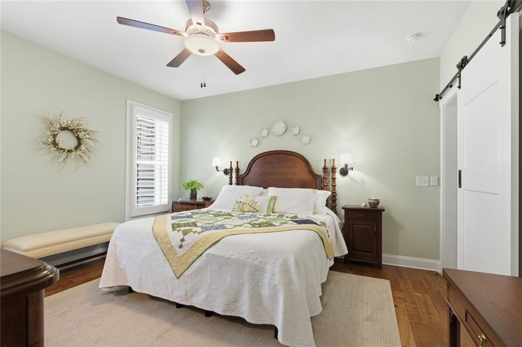 7671 Fern Lane Lula, GA 30554 - Photo 24 of 67 a bedroom with a bed and a chandelier