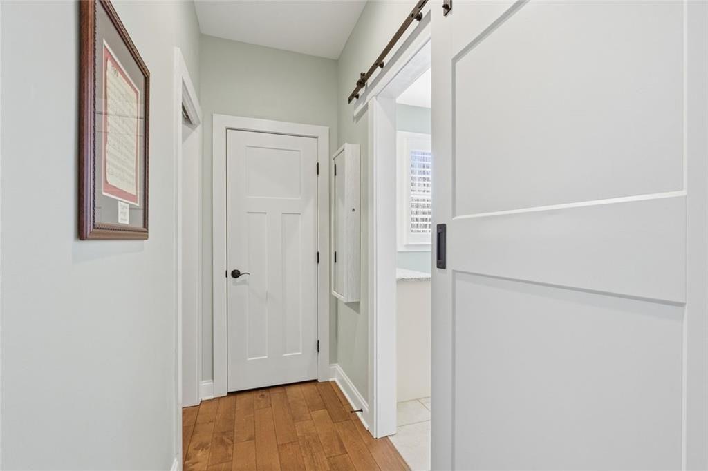 7671 Fern Lane Lula, GA 30554 - Photo 26 of 67 a view of a hallway with wooden floor and closet