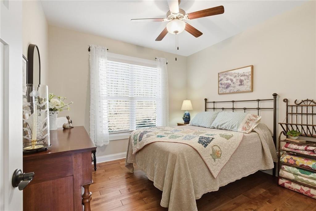 7671 Fern Lane Lula, GA 30554 - Photo 33 of 67 a bedroom with a bed and a chandelier