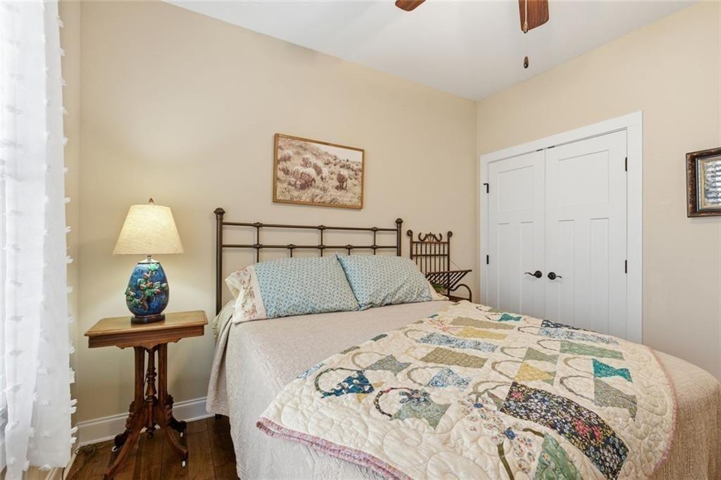 7671 Fern Lane Lula, GA 30554 - Photo 34 of 67 a bedroom with a bed and a lamp on table