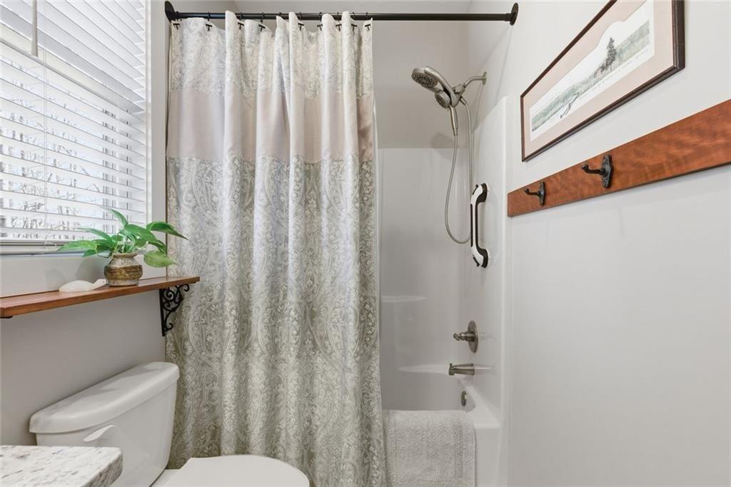 7671 Fern Lane Lula, GA 30554 - Photo 36 of 67 a bathroom with a toilet and a shower curtain