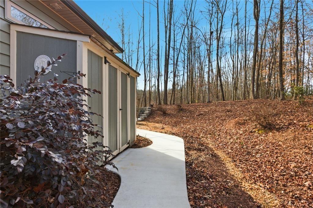 7671 Fern Lane Lula, GA 30554 - Photo 47 of 67 a front view of a house with garden