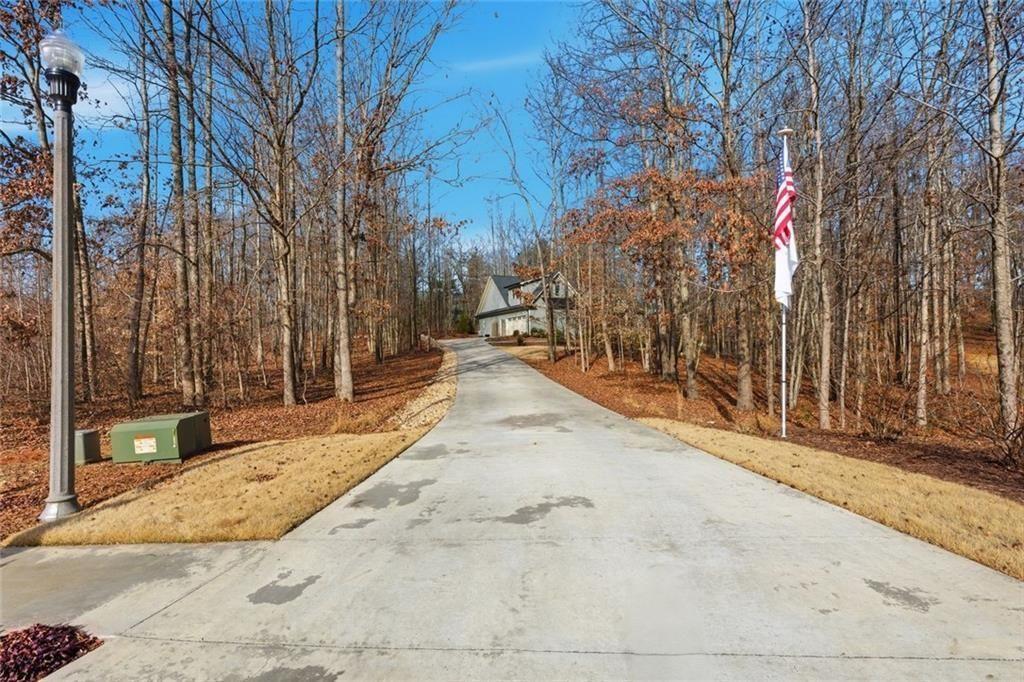 7671 Fern Lane Lula, GA 30554 - Photo 58 of 67 a view of a backyard with large trees