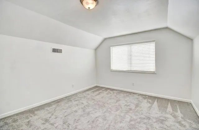 a view of swimming pool with lawn chairs under an umbrella