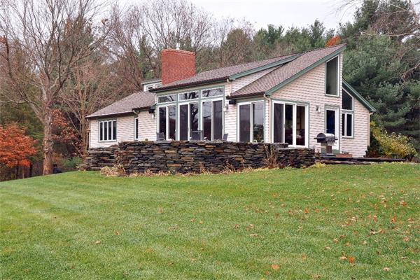 99 Concord Road Wayland, MA 01778 - Photo 2 of 12 a front view of a house with a garden