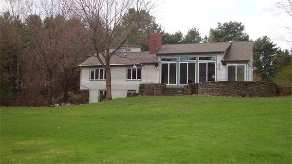 99 Concord Road Wayland, MA 01778 - Photo 8 of 12 a front view of a house with a garden