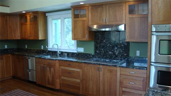 99 Concord Road Wayland, MA 01778 - Photo 10 of 12 a kitchen with granite countertop wooden cabinets and entryway