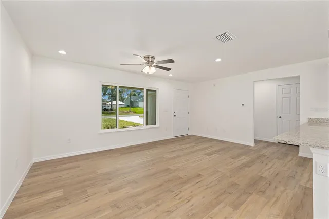 wooden floor in an empty room with a window