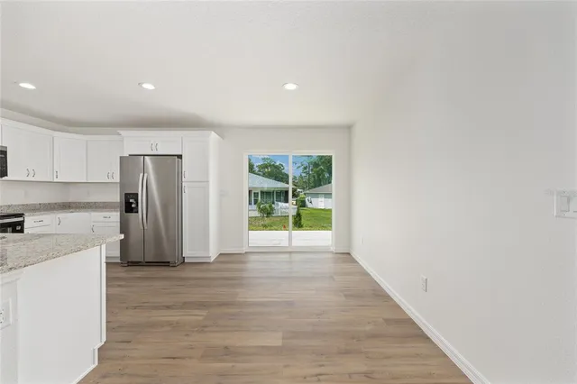 a view of a kitchen with a sink and a refrigerator