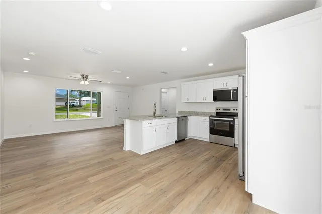 a kitchen with stainless steel appliances kitchen island wooden cabinets and granite counter tops