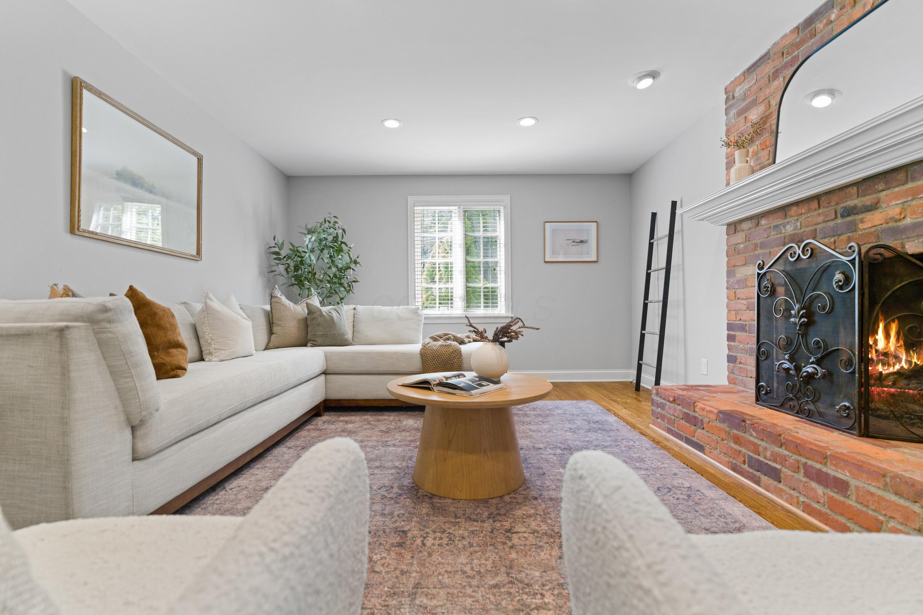 1326 Windham Road Columbus, OH 43220 - Photo 22 of 67 Family Room with a lovely brick fireplace and hearth and canned lighting!