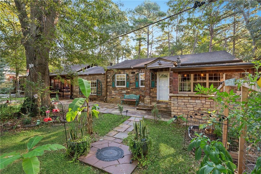 a front view of a house with a yard table and chairs