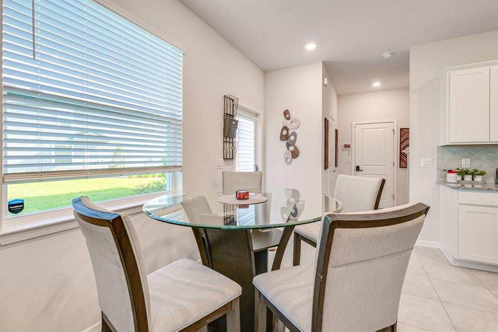 5443 Elmview Crossing Wesley Chapel, FL 33545 - Photo 13 of 41 a view of a dining room with furniture and window