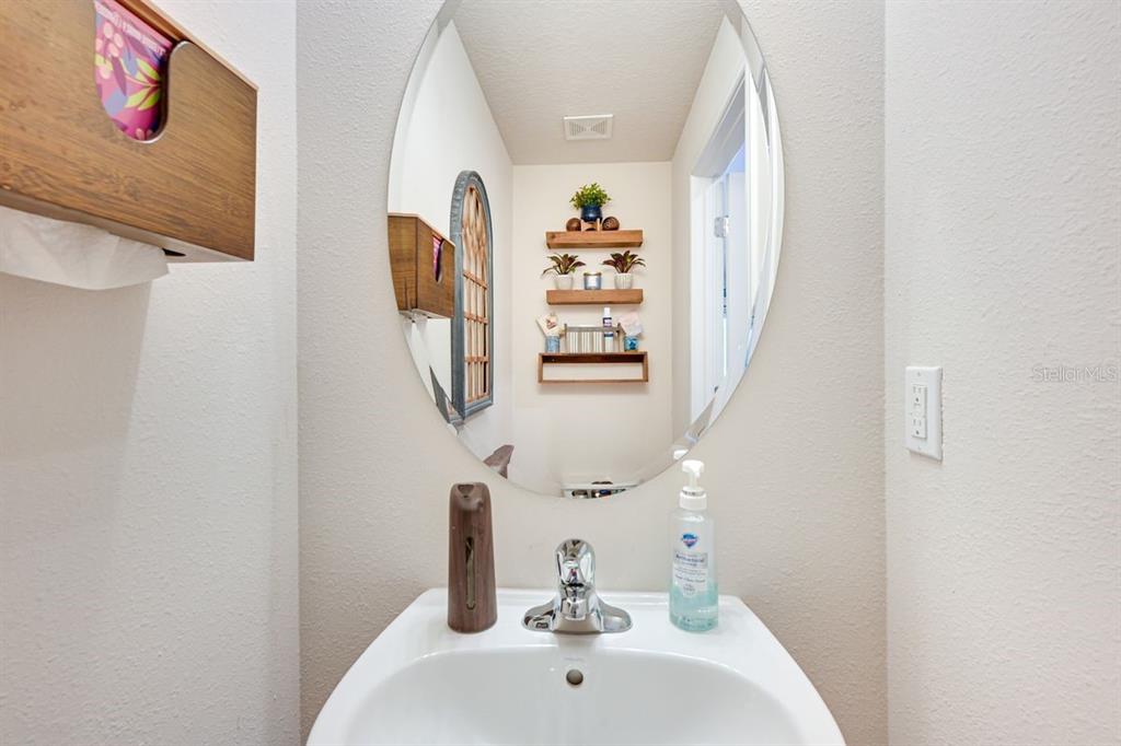5443 Elmview Crossing Wesley Chapel, FL 33545 - Photo 14 of 41 a bathroom with a sink and mirror