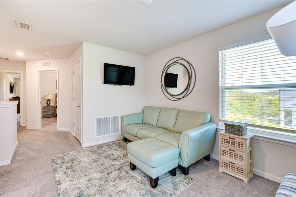 5443 Elmview Crossing Wesley Chapel, FL 33545 - Photo 16 of 41 a living room with furniture and a flat screen tv