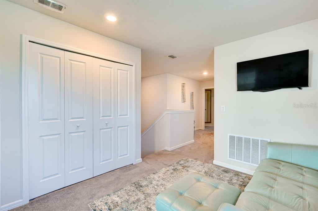 5443 Elmview Crossing Wesley Chapel, FL 33545 - Photo 17 of 41 a living room with furniture and a flat screen tv