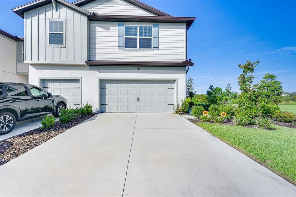 5443 Elmview Crossing Wesley Chapel, FL 33545 - Photo 30 of 41 a house view with a garden space