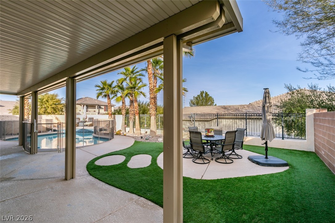 7524 Midnight Rambler Street Las Vegas, NV 89149 - Photo 42 of 51 A spacious covered patio with a seating area overlooks the private pool and landscaped yard.
