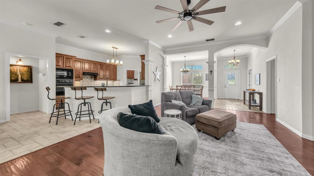 203 Mockingbird Lane Aledo, TX 76008 - Photo 12 of 37 Open-concept living area with dark wood-finish flooring, a ceiling fan, and recessed lighting