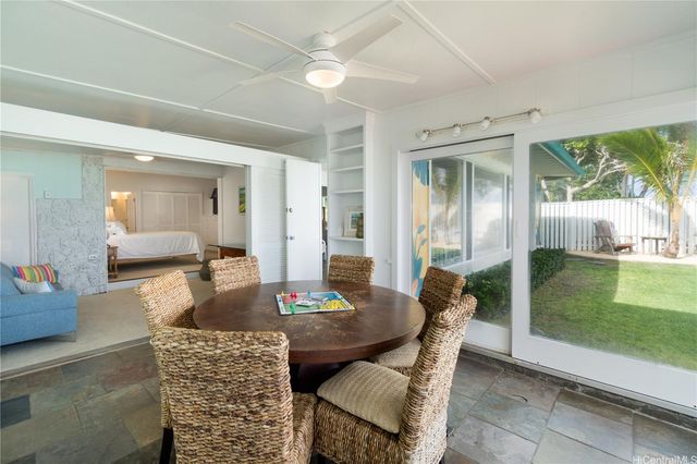 a dining room with furniture and a floor to ceiling window