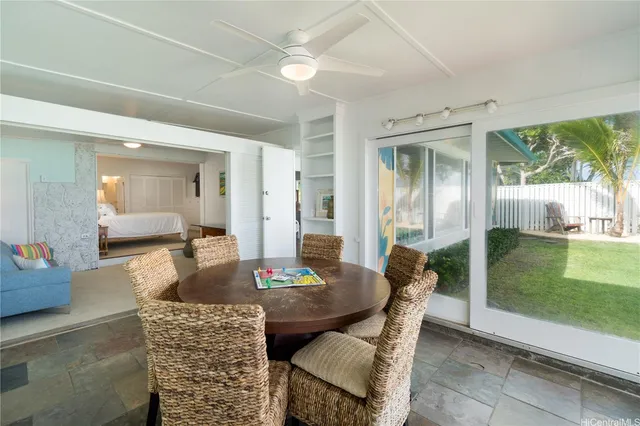 a dining room with furniture and a floor to ceiling window