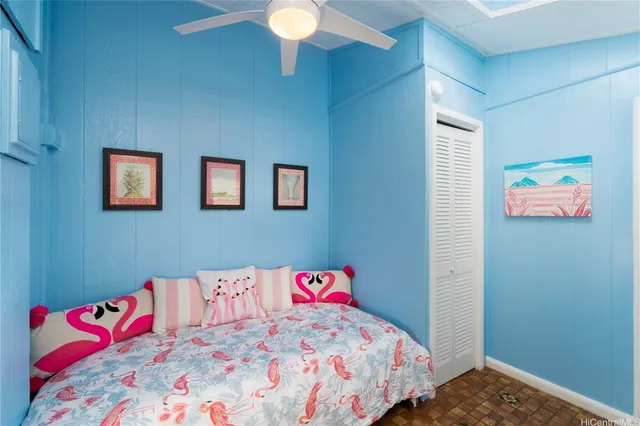 a bedroom with a bed and a painting on the wall