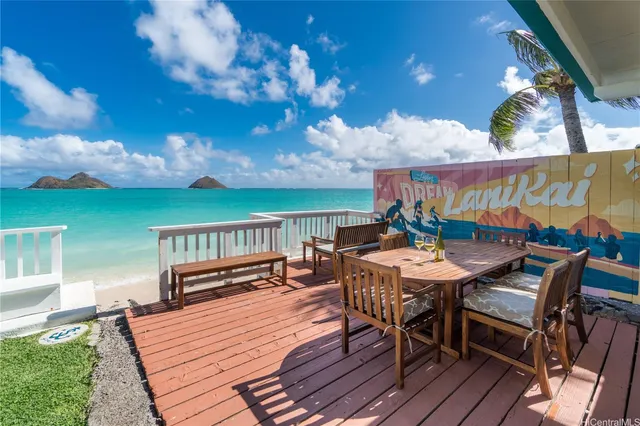 a view of a patio with table and chairs with wooden floor and fence
