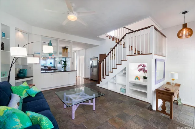 a living room with furniture and kitchen view