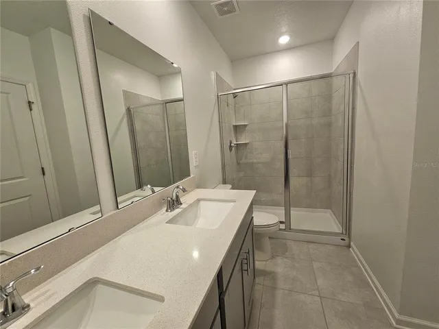 a bathroom with a sink and mirror with toilet