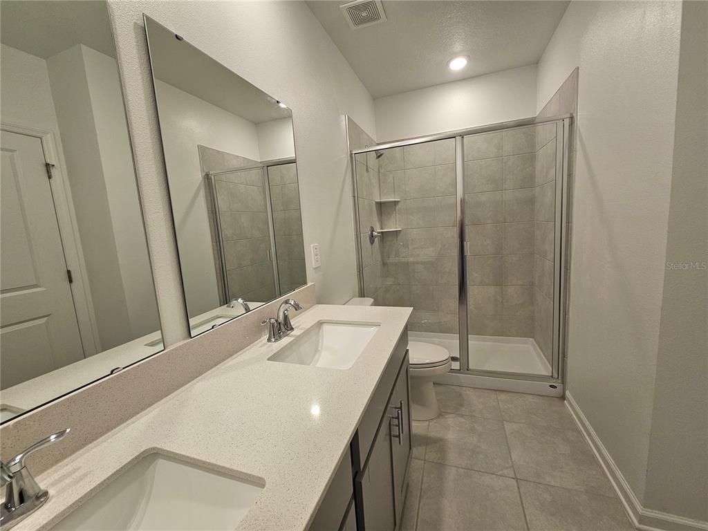 2629 Runners Circle Clermont, FL 34714 - Photo 11 of 22 a bathroom with a sink a toilet and shower
