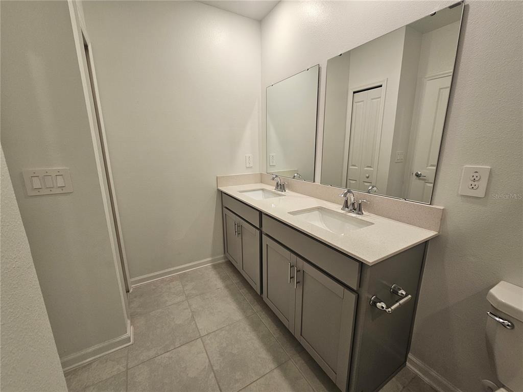 2629 Runners Circle Clermont, FL 34714 - Photo 12 of 22 a bathroom with a sink and mirror with toilet