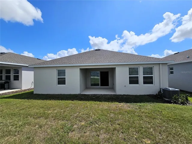 an aerial view of residential house with outdoor space and swimming pool