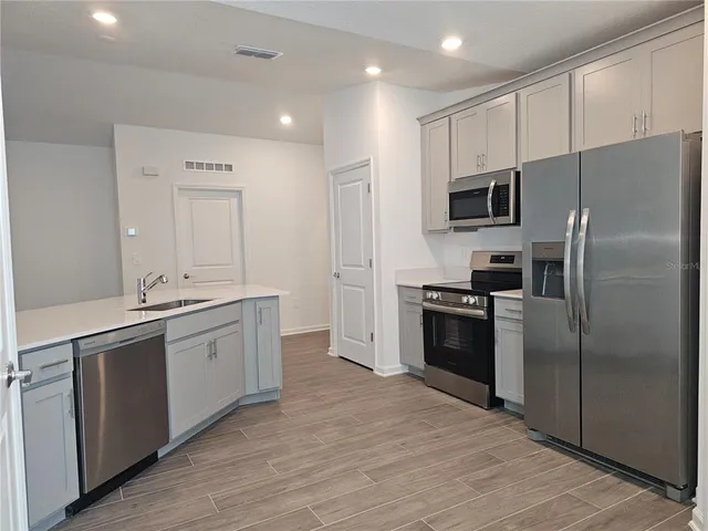 a view of a kitchen with stainless steel appliances