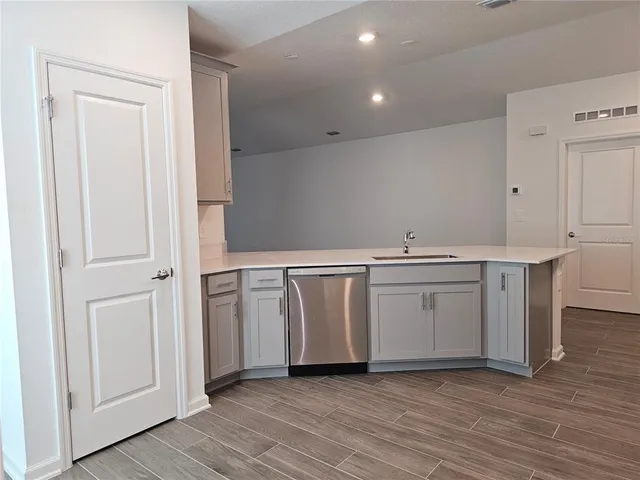 a view of a kitchen with closet and wooden floor