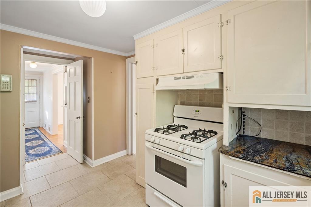 311 Ashland Road Middlesex, NJ 08846 - Photo 11 of 23 a kitchen with white cabinets and appliances