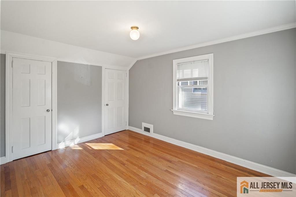 311 Ashland Road Middlesex, NJ 08846 - Photo 18 of 23 a view of an empty room with wooden floor and a window