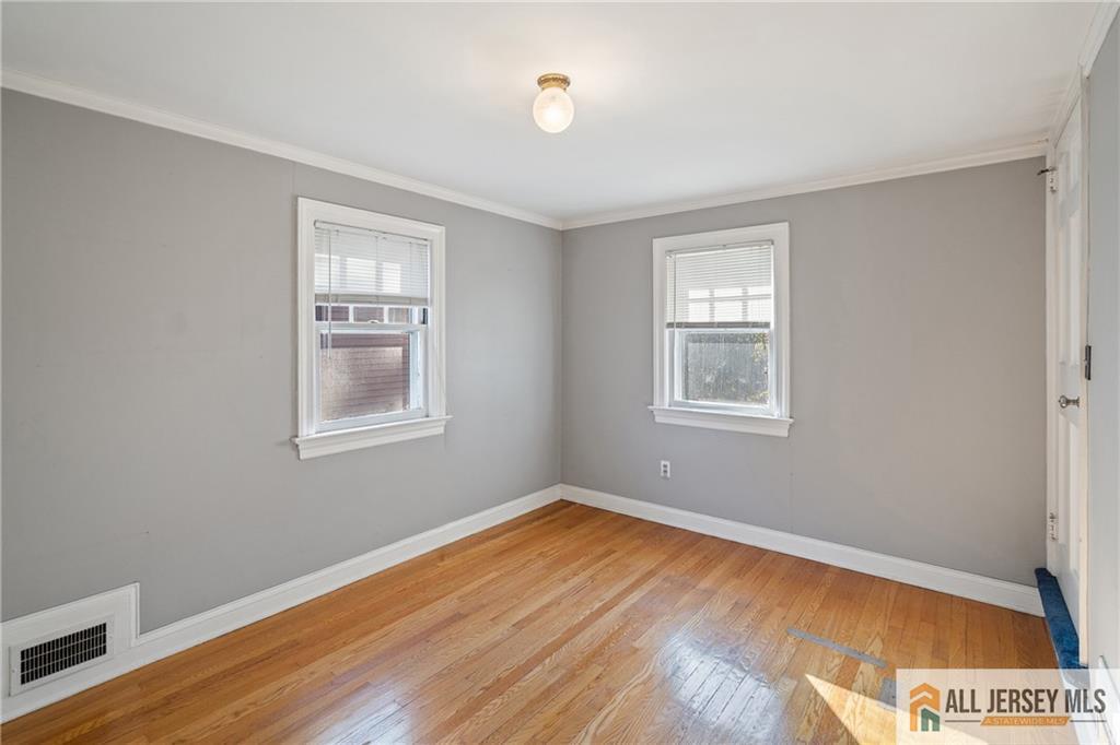 311 Ashland Road Middlesex, NJ 08846 - Photo 19 of 23 a view of empty room with wooden floor and fan