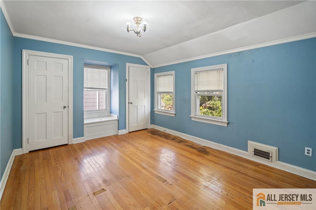 311 Ashland Road Middlesex, NJ 08846 - Photo 21 of 23 a view of an empty room with a window and wooden floor